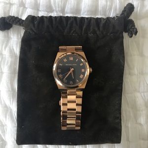 Rose gold with black face Michael Kors watch